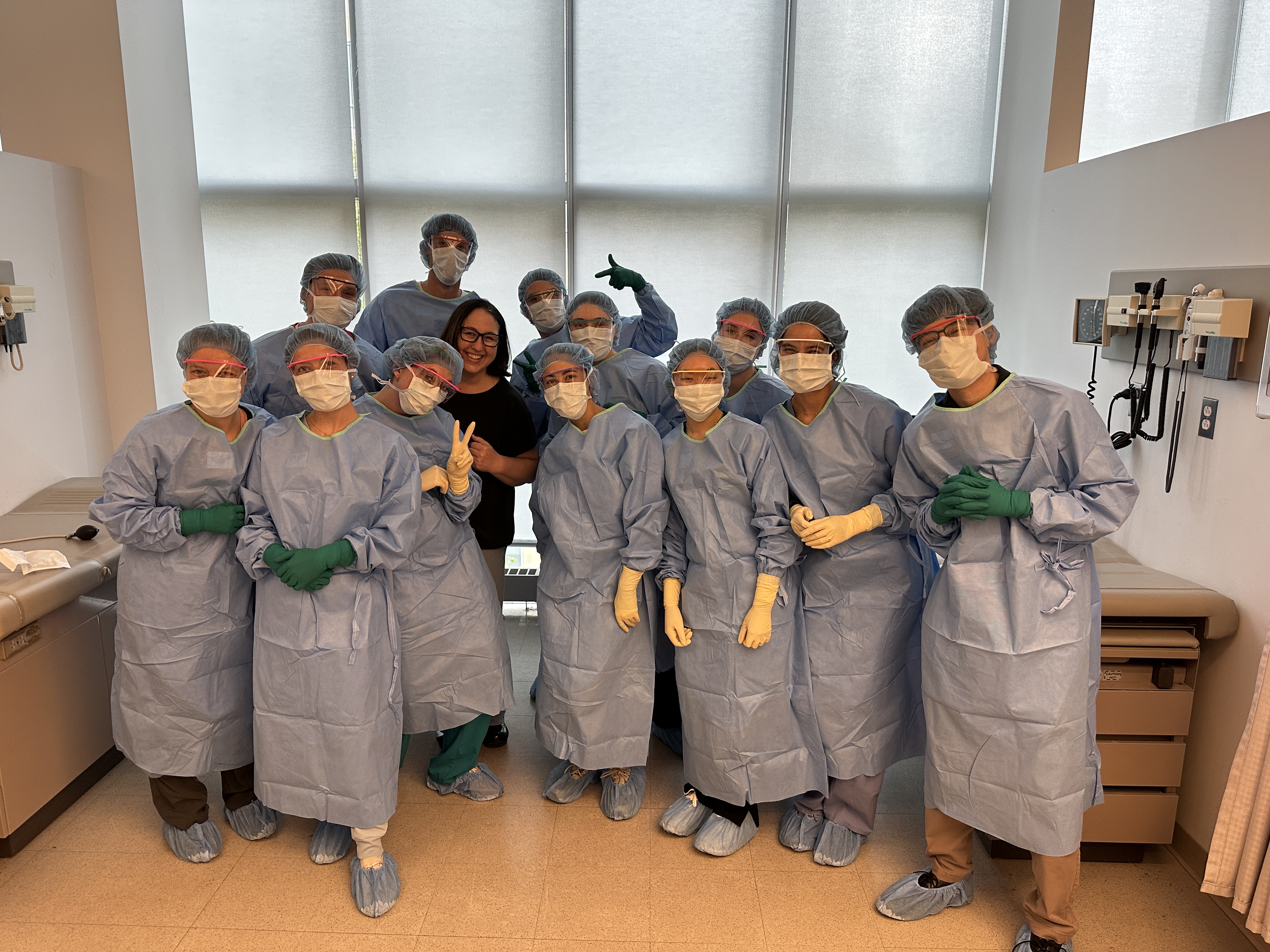 A photo of PA students wearing surgical PPE after learning how to scrub in.